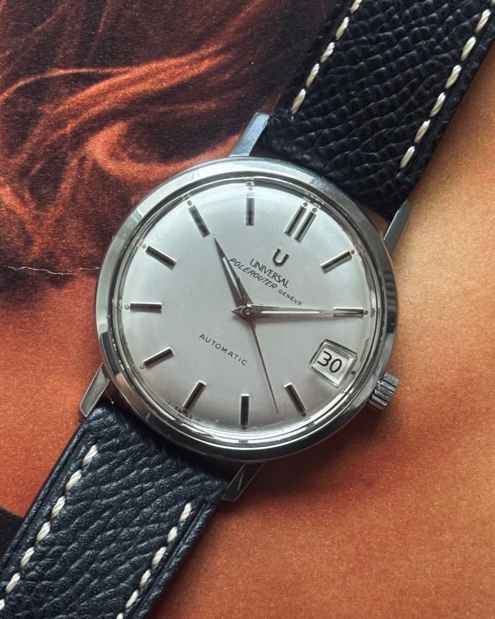 Universal Genève automatic with silver dial on a navy stitched strap